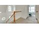 Carpeted staircase with wooden banister and landing with lots of natural light at 1835 Montague Rd, Clover, SC 29710