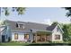 A view of the home's back featuring a covered patio with comfortable seating and a well-maintained yard at 1905-A Bechtler Rd, Edgemoor, SC 29712