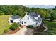 Aerial view showcasing a home, separate garage, mature trees, driveway and green lawn at 1920 Williford Woods Ln # 5, Rock Hill, SC 29730