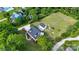 Aerial view of a home with a dark roof, stone patio, outbuilding, fire pit, and mature trees at 1920 Williford Woods Ln # 5, Rock Hill, SC 29730