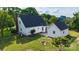Expansive backyard featuring a white home with an outbuilding, a stone patio, and a cozy fire pit at 1920 Williford Woods Ln # 5, Rock Hill, SC 29730