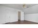 Bedroom featuring wood-look flooring, white walls, ceiling fan, and two white interior doors at 1920 Williford Woods Ln # 5, Rock Hill, SC 29730