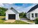 Exterior view showcasing the home, a garage with wood ramp, a brick path, and mature trees at 1920 Williford Woods Ln # 5, Rock Hill, SC 29730