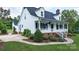 Well maintained home featuring a welcoming front porch, dormer windows, green lawn, and mature landscaping at 1920 Williford Woods Ln # 5, Rock Hill, SC 29730