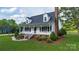 Traditional home featuring a welcoming front porch, dormer windows, green lawn, and mature landscaping at 1920 Williford Woods Ln # 5, Rock Hill, SC 29730