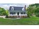 Traditional home featuring a welcoming front porch, dormer windows and lush green lawn at 1920 Williford Woods Ln # 5, Rock Hill, SC 29730