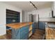 This spacious kitchen features a butcher block island, stainless steel appliances, and stylish blue cabinets at 1920 Williford Woods Ln # 5, Rock Hill, SC 29730