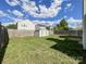 Large, fenced backyard with a storage shed and plenty of green space at 2713 Reid Meadows Dr, Charlotte, NC 28208