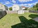 Fenced backyard featuring well-maintained grass and a convenient storage shed at 2713 Reid Meadows Dr, Charlotte, NC 28208