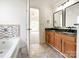 Bathroom with double vanity, granite countertops, and view to the main bedroom at 2713 Reid Meadows Dr, Charlotte, NC 28208