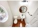 Modern bathroom featuring a pedestal sink and a round mirror at 2713 Reid Meadows Dr, Charlotte, NC 28208
