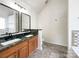 Spacious bathroom with double vanity, granite countertops, and decorative tile accents at 2713 Reid Meadows Dr, Charlotte, NC 28208