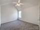 Bedroom featuring neutral carpet, a ceiling fan, and a window at 2713 Reid Meadows Dr, Charlotte, NC 28208