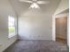 Bedroom featuring neutral carpet, a ceiling fan, and a window at 2713 Reid Meadows Dr, Charlotte, NC 28208