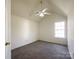 Bedroom featuring neutral carpet, a ceiling fan, and a window at 2713 Reid Meadows Dr, Charlotte, NC 28208