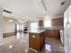 Spacious kitchen with island open to the living area featuring a fireplace and vaulted ceiling at 2713 Reid Meadows Dr, Charlotte, NC 28208