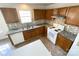 A well-lit kitchen featuring matching cabinets, modern countertops, backsplash, and white appliances at 2713 Reid Meadows Dr, Charlotte, NC 28208