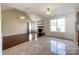 Open living space with hardwood floors, a fireplace, and a smooth transition to the tiled kitchen area at 2713 Reid Meadows Dr, Charlotte, NC 28208