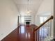 Bright living room with vaulted ceilings, hardwood floors, large windows, and a cozy fireplace at 2713 Reid Meadows Dr, Charlotte, NC 28208