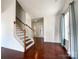 Bright living room featuring hardwood floors, staircase, and large windows with lots of natural light at 2713 Reid Meadows Dr, Charlotte, NC 28208