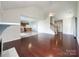 Spacious living room with hardwood floors seamlessly flowing into the adjacent kitchen space at 2713 Reid Meadows Dr, Charlotte, NC 28208