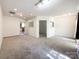 A spacious living room area with passthrough windows into an adjacent room at 2713 Reid Meadows Dr, Charlotte, NC 28208