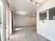A spacious living room area with passthrough windows into an adjacent room at 2713 Reid Meadows Dr, Charlotte, NC 28208