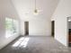 Spacious main bedroom with neutral carpet, a ceiling fan, and multiple windows at 2713 Reid Meadows Dr, Charlotte, NC 28208