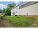 Backyard featuring a healthy lawn, stepped patio, partial fence, and beautiful landscaping at 305 Phillip Dr, Salisbury, NC 28146