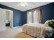 Bedroom featuring a walk-in closet, ceiling fan, and dark blue walls at 305 Phillip Dr, Salisbury, NC 28146