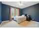 Bedroom with large windows, ceiling fan, and dark blue walls at 305 Phillip Dr, Salisbury, NC 28146