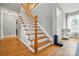 Entryway with hardwood floors and stairs featuring white risers and wood railing at 305 Phillip Dr, Salisbury, NC 28146