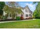 Charming two-story home featuring red shutters and a beautifully landscaped front yard at 305 Phillip Dr, Salisbury, NC 28146