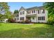 Charming two-story home featuring red shutters and a beautifully landscaped front yard at 305 Phillip Dr, Salisbury, NC 28146