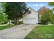 Home featuring a two-car garage, neutral siding, and mature landscaping at 305 Phillip Dr, Salisbury, NC 28146