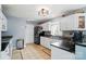 Traditional kitchen features white cabinets, black countertops, and tile flooring at 305 Phillip Dr, Salisbury, NC 28146