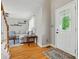Bright living room featuring hardwood floors, a white door with a decorative window, and comfortable seating at 305 Phillip Dr, Salisbury, NC 28146