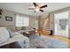 Comfortable living room featuring hardwood floors, a ceiling fan, a sectional sofa, and staircase at 305 Phillip Dr, Salisbury, NC 28146