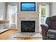 Elegant living room featuring a marble fireplace, a mounted TV, and natural light from surrounding windows at 305 Phillip Dr, Salisbury, NC 28146
