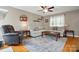 Comfortable living room featuring hardwood floors, a ceiling fan, and a large sectional sofa at 305 Phillip Dr, Salisbury, NC 28146