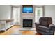 Elegant living room featuring a marble fireplace, a mounted TV, and natural light from surrounding windows at 305 Phillip Dr, Salisbury, NC 28146
