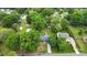 Aerial view showcasing the home's landscaped yard, mature trees, and proximity to neighborhood amenities at 324 Autumn Dr, Harrisburg, NC 28075