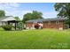 Expansive grassy backyard with patio and pergola, perfect for outdoor entertaining and relaxation at 324 Autumn Dr, Harrisburg, NC 28075