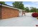 The backyard offers a brick patio with French doors, a sink, and flowers adding color to the space at 324 Autumn Dr, Harrisburg, NC 28075