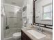 Bathroom with glass door shower, granite countertop, and natural light from the window at 324 Autumn Dr, Harrisburg, NC 28075