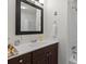 Modern bathroom features a vanity with a dark wood cabinet, white countertop, and tiled shower at 324 Autumn Dr, Harrisburg, NC 28075