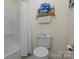 Well-lit bathroom featuring a toilet, bathtub with shower, and stylish decor for a cozy feel at 324 Autumn Dr, Harrisburg, NC 28075
