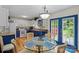 Bright kitchen with dining area, blue cabinets, granite countertops and backyard view at 324 Autumn Dr, Harrisburg, NC 28075