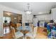 Open dining area adjacent to the kitchen with blue accents and hardwood flooring at 324 Autumn Dr, Harrisburg, NC 28075