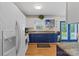 Charming kitchen features blue cabinets, granite counters, and access to the backyard at 324 Autumn Dr, Harrisburg, NC 28075